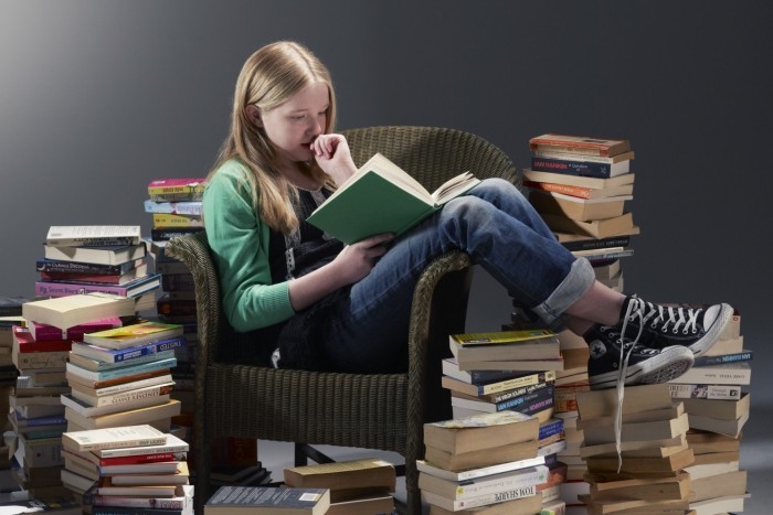 girl reading pile of books700